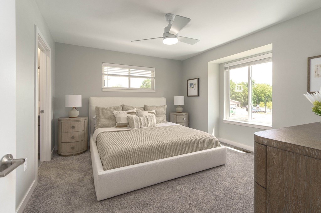 a bedroom with a bed and a ceiling fan